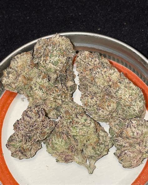 This bud has dense rounded bright green nugs with amber undertones, dark hairs and a coating of milky amber. . Purple space truffle strain